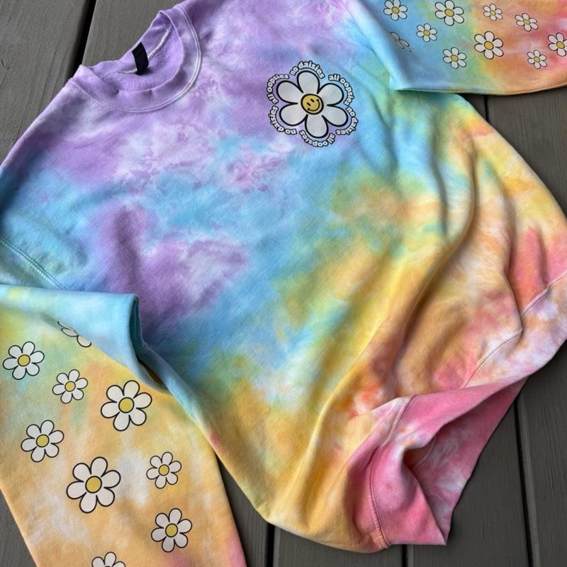 All oopsies no daisies. Whimsy, tiedye. Arm designs. Crewneck